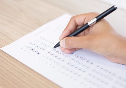 Closeup of Person Filling out Questionary Form